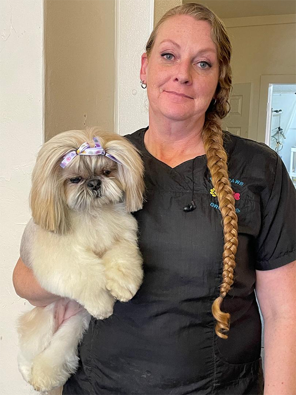 Groomer with an adorable puppy